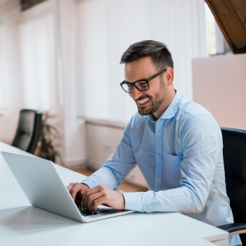 Image-happy-young-businessman-using-laptop-his-office-desk (2)
