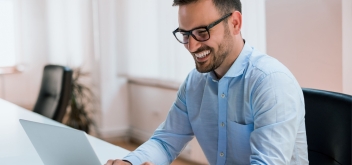 Image-happy-young-businessman-using-laptop-his-office-desk (2)