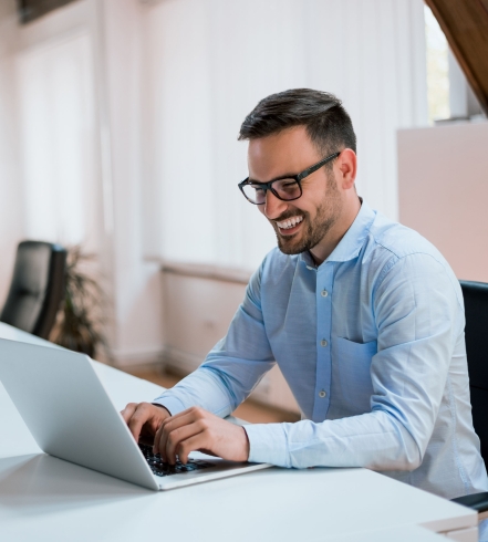 Image-happy-young-businessman-using-laptop-his-office-desk (2)