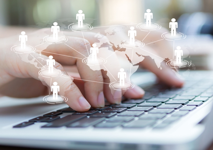 Image-hands-with-laptop-virtual-world-map (1)